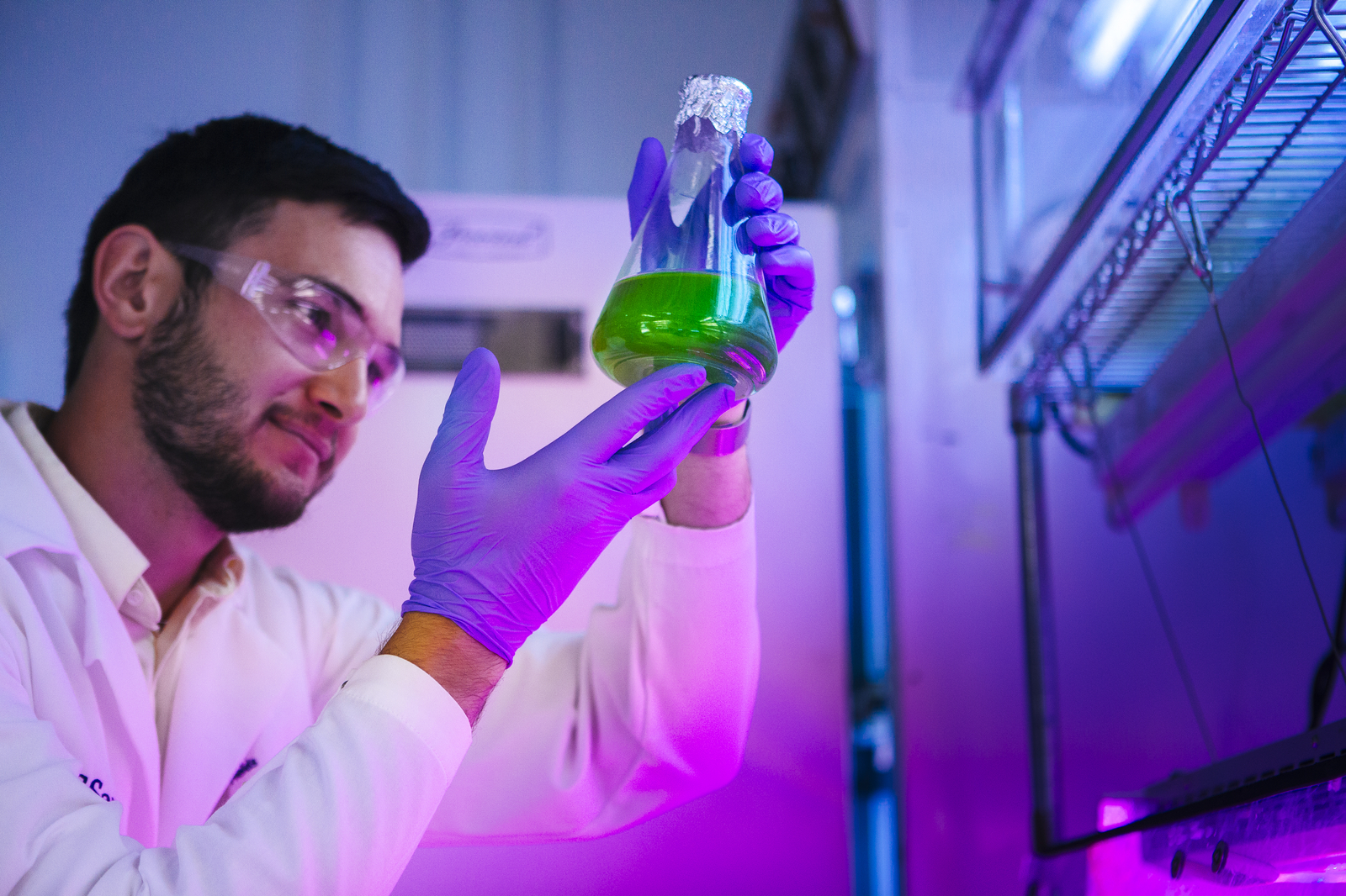 UCH DEI professor holding up test tube