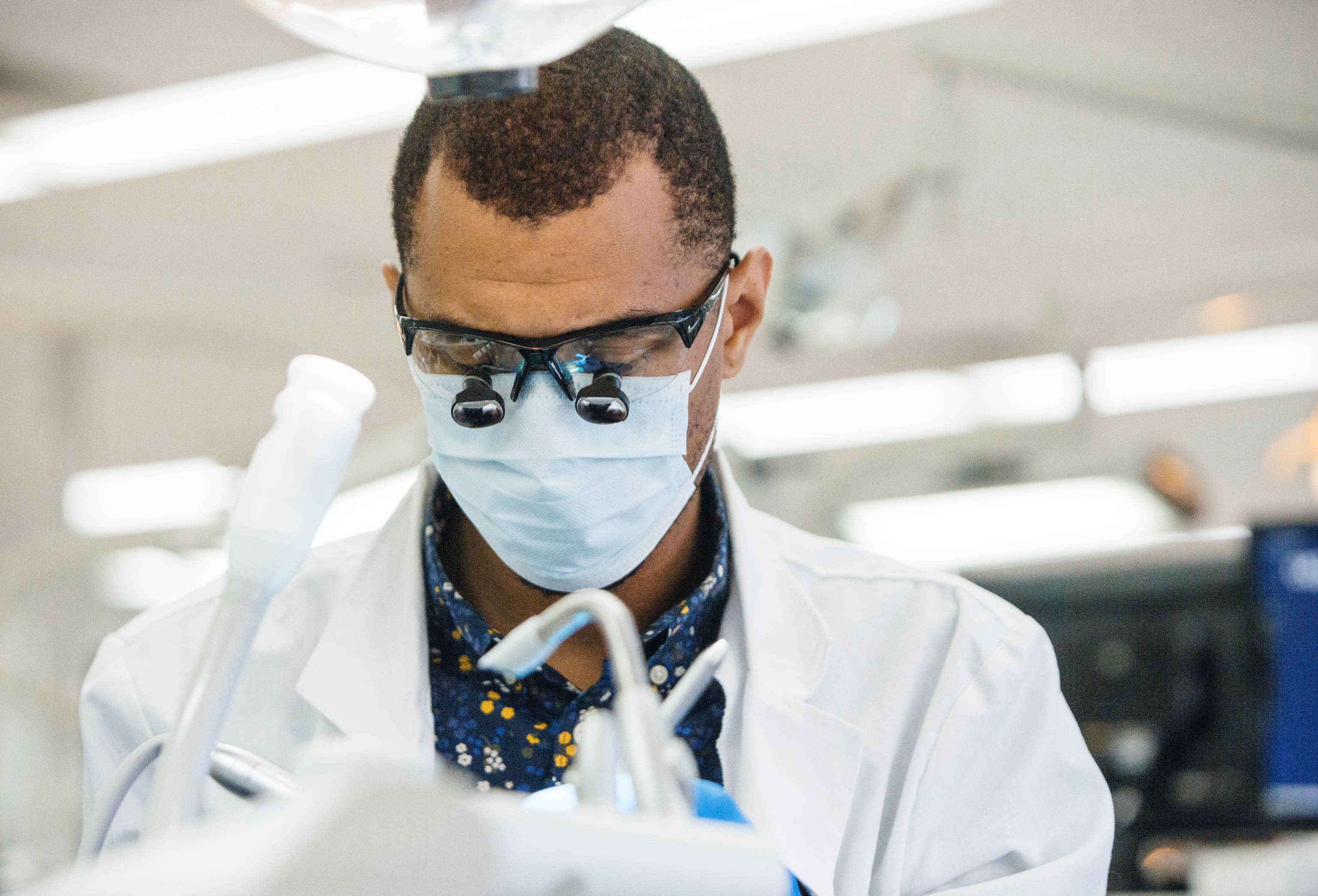 UCAL medical physician looking in microscope