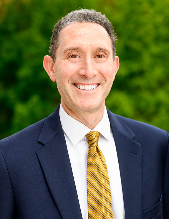 S. Andrew Josephson, UCSF school of medicine dean and Vice Chancellor for Clinical Affairs, pictured in a suit in front of a background of foliage