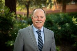 Photo of Timothy J. Collins, CEO of UCR Health
