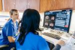 Two UC Health providers review information in an electronic health record