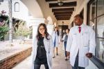 group of medical students in white coats walking