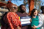 photo of a student holding an "I matched" sign with his family