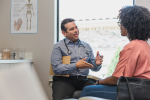 image of a health professional smiling at a patient inside a doctor's office