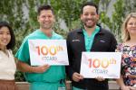 Two men and two women holding sign that says TCAR 100
