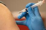 A person's arm is shown getting the vaccine