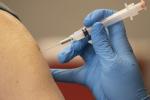 Ann arm is seen receiving the COVID 19 vaccine