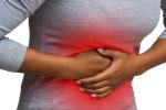 A woman holds on to her stomach which is accentuated with a red zone that indicates pain in the abdominal cavity.