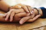 Two Black hands holding each other