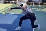 Cheryl Joordens playing pickleball and swinging racket low over the court.
