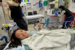 Woman lying in hospital bed. 