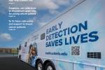 Magazine cover with word Synthesis and a blue and white bus with the image of two women and the words Early Detection Saves Lives