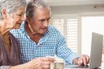 Older man and woman looking at computer