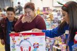 Woman and boy shop for toys. 