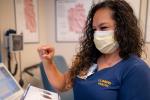 Irene Cisneros-Fong holds pacemaker in hand while looking at it