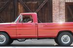 Young man in a red vintage truck