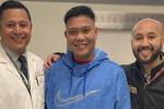 Three men standing arm in mark together