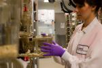 Woman pulling box out in lab