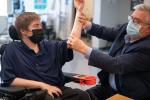 Dr. Craig McDonald with a boy with Duchenne muscular dystrophy. The boy is placing blocks on top of each other.