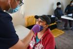 Migrant farmworker Maria Lopez gets a COVID-19 nasal swab test in Madison, a rural community east of Woodland