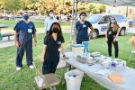 Volunteers from the UC Davis School of Medicine and the Betty Irene Moore School of Nursing give COVID-19 shots at the Oak Park Farmers Market.