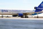 A white and blue plane with the words “Orbis” and “Flying Eye Hospital” is on an airport tarmac.