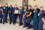 Nurse Manager Darrell Desmond, third from left, and Accelerated Access Unit members celebrate their PRISM Award.