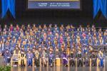 Nursing graduates and faculty sitting in risers on stage