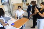 High school students stand around hospital bed in simulation with manikin to learn health care skills