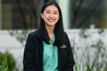 Portrait of third-year medical student Samantha Wong wearing scrubs outside School of Medicine Education Building