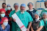 Group of people posing with green scrubs