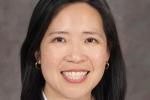 Elisa Tong wearing a white coat