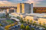 Aerial view of UC Davis Medical Center during the day with the skyline of Sacramento in the distance.