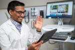 Dr Vinu Ninan wearing a white coat during a virtual health visit