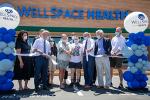 A group of people including UC Davis School of Medicine Interim Dean Susan Murin stand before WellSpace Health sign 