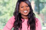Black woman with long dark hair, pink blouse 