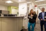 Three people walk together in a clinic hallway 