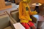 A boy in a big bird costume in a medical waiting room