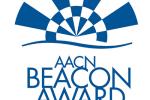 A white square with blue image and lettering that states “AACN Beacon Award for Excellence”