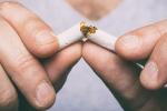 Male hands breaking a cigarette in half