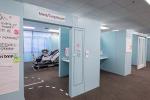Row of mock-up patient rooms with notes on them