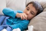 Child coughing in bed