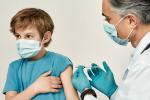 Nurse gives child shot in the arm