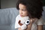 Child hugging stuffed animal