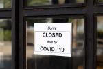 Closed due to COVID-19 sign in front of an office building