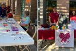 left photo: three adults, two wearing masks, are gathered outside around a table with beads arranged in boxes. Two are seated and one is standing. An orange sign behind them says “Bead Art.”, right photo: Two adults dressed in maroon T-shirts stand behind a long table that is filled with toys and prizes, flyers, a banner that says “Warmline family resources center” and a black game that says “prize drop.”