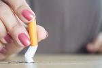 Female hand crushing cigarette