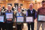 Five professors (three women and two men) hold framed plaques with award certificates from School of Medicine curriculum leaders