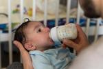 Man feeding baby