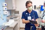 resident and doctor speaking in patient room